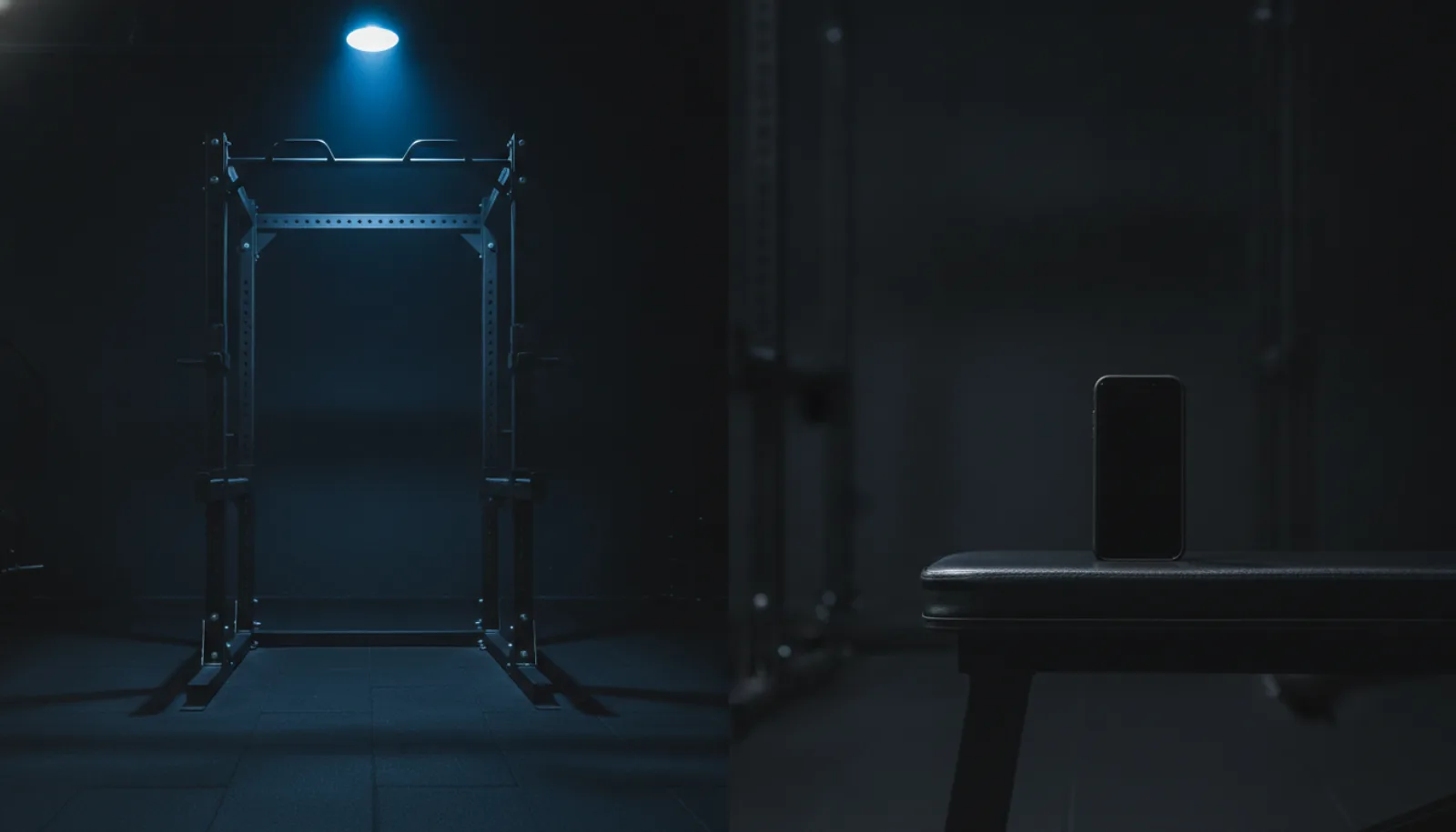 An empty squat rack on one side and a phone propped on a bench on the other